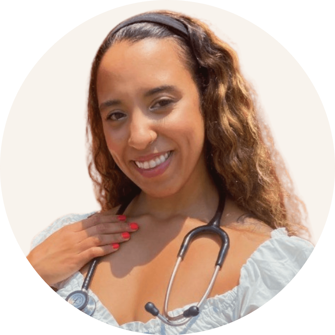 Desiree Kitsmiller smiling, with long wavy dark hair and a headband, a stethoscope around her neck