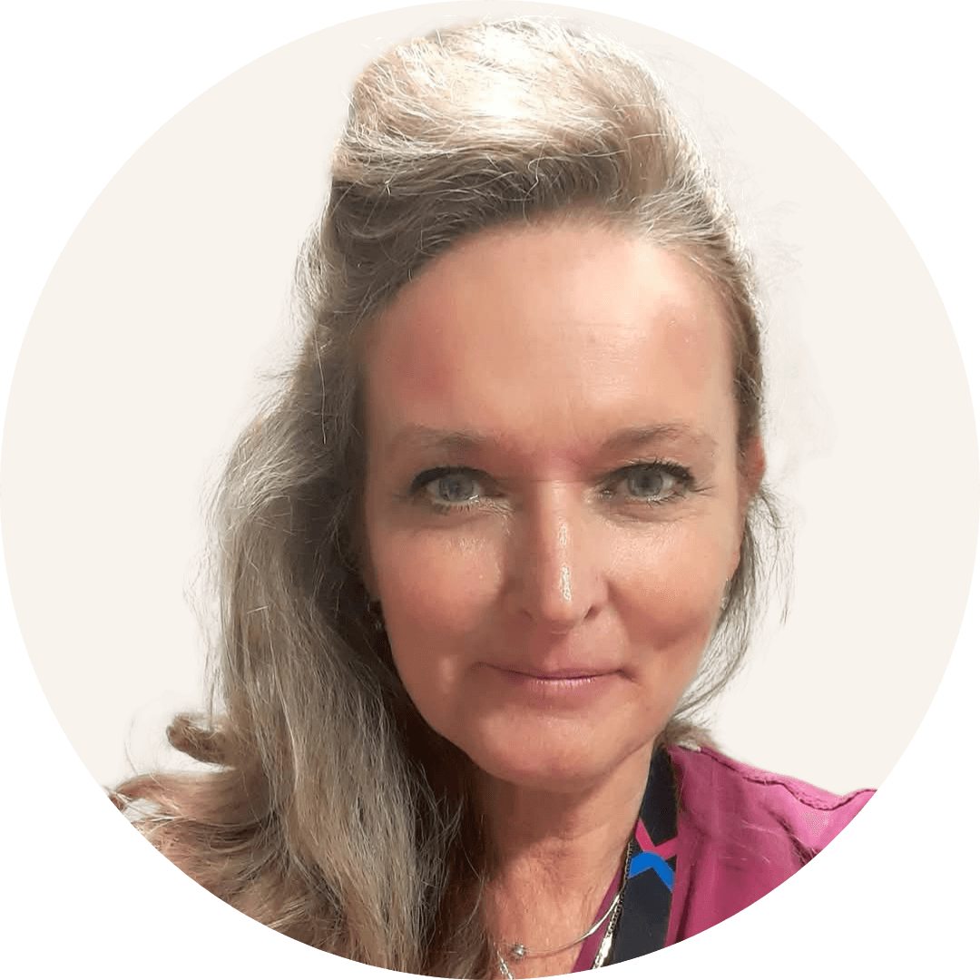 Dr Lindsey Forster, with long fair hair pinned up, wearing a pink top