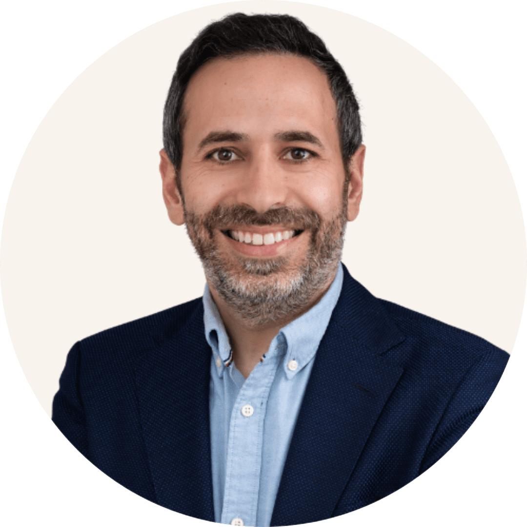 Dr Mohammad Husban smiling, with a short greying beard, wearing a navy blazer over a light blue shirt