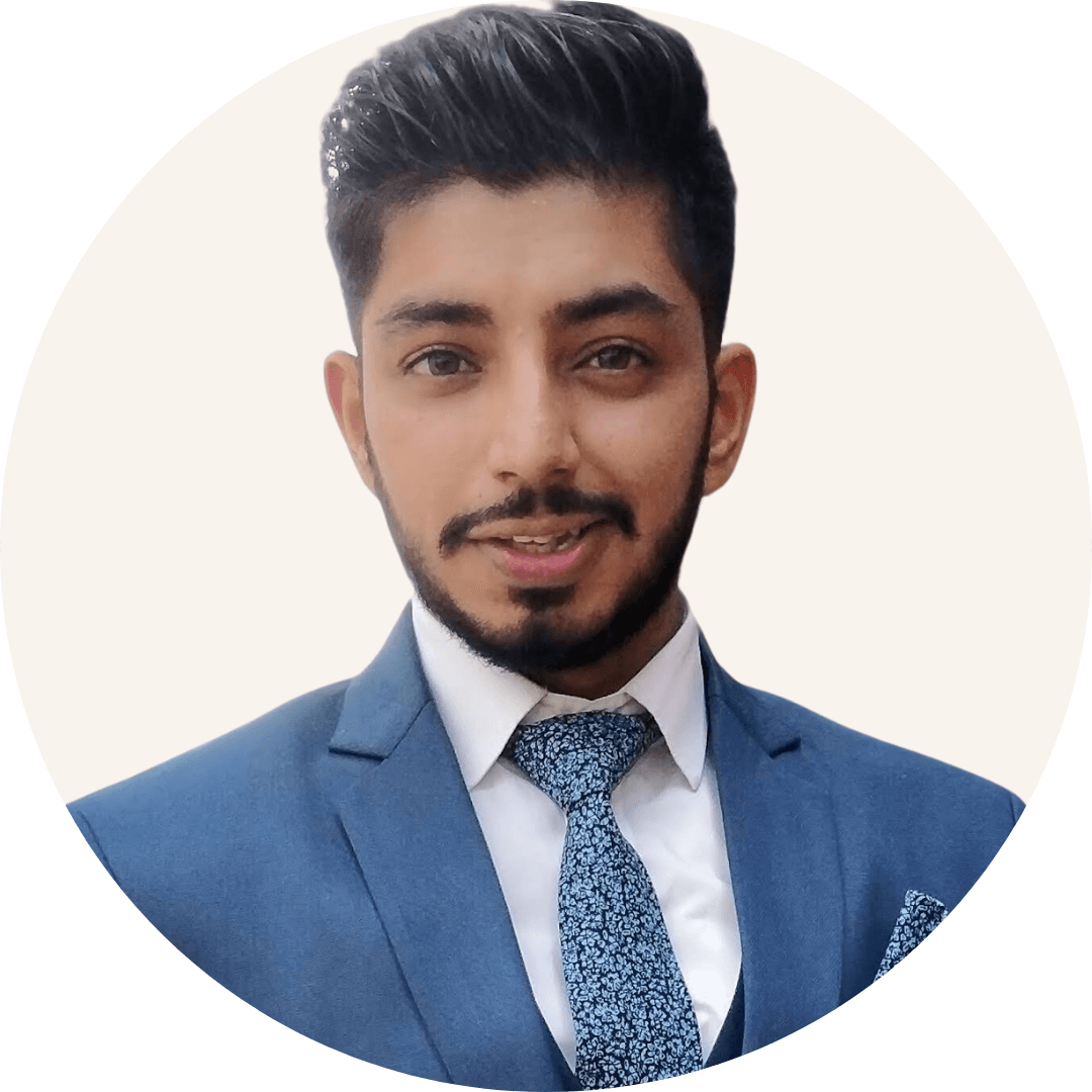 Shubham Mehta, with dark styled hair and a trimmed beard, wearing a blue suit, a white shirt and a patterned tie
