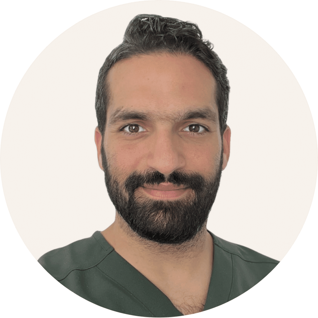 Dr Khaled Elgamaz, with dark hair and a full beard, wearing dark green scrubs