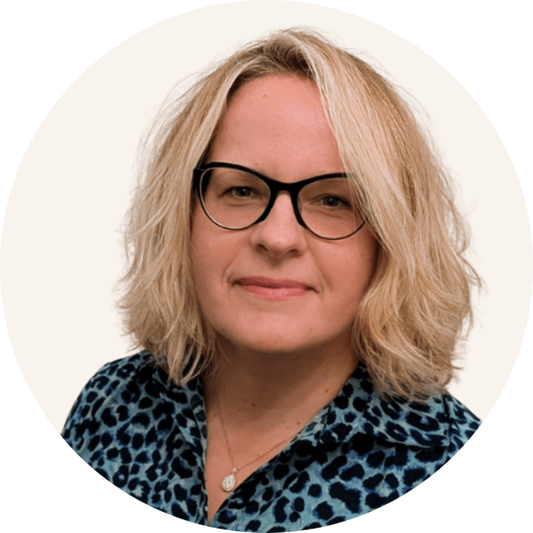 Dr Karolina Szumanska-Ryt, with shoulder-length blonde hair and dark-rimmed glasses, wearing a blue leopard-print top